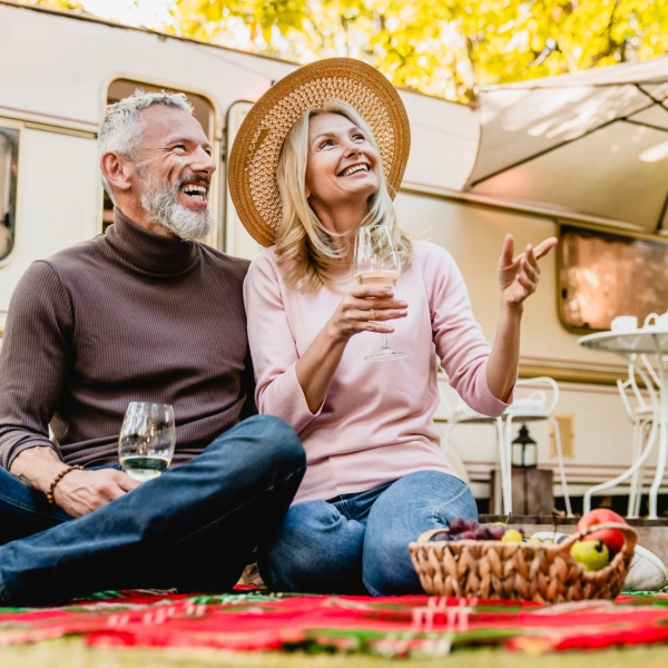 Happy Couple Enjoying Picnic Infront Of Rv 600X600
